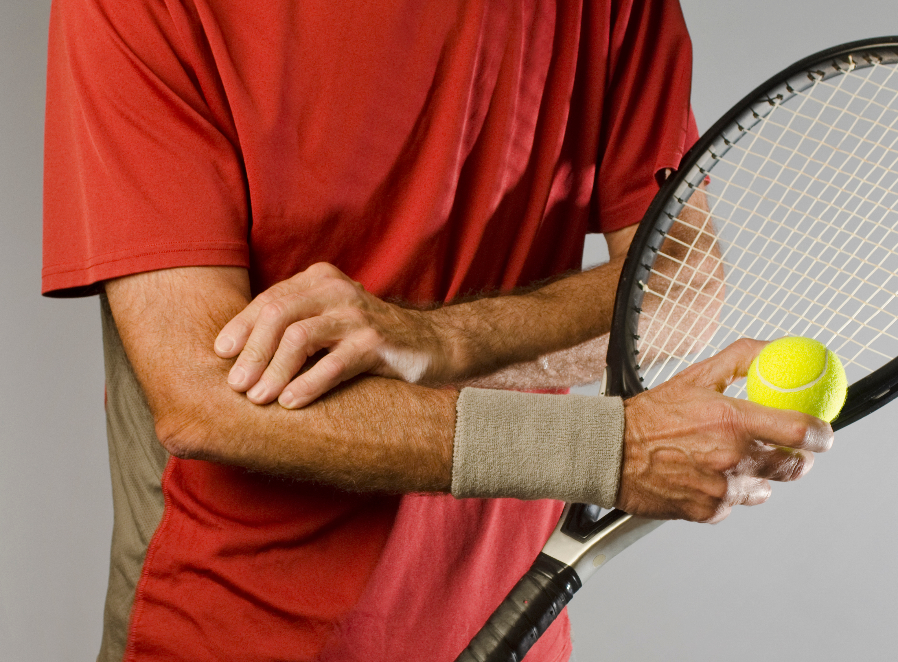 male tennis player with tennis elbow